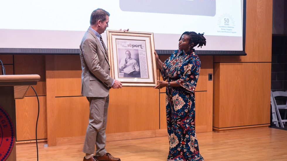 A man is seen accepting a large frame from a woman